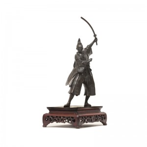A Brozne standing samurai with his sward
