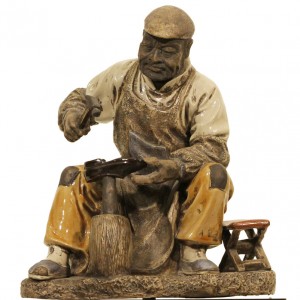 Plaster figure of a shoe repairer