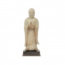 A porcelain figure of monk in praying posture