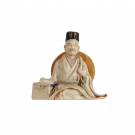 A Japanese porcelain seated scholar