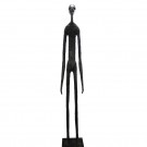 Wooden carving of a standing skinny man