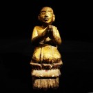 A wooden kneeling Burmese monk