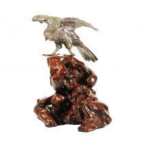 A Japanese silver eagle with wooden base