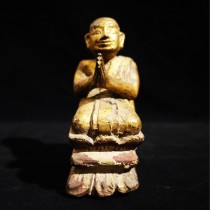 A wooden kneeling Burmese monk