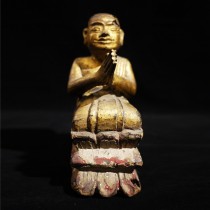 A wooden kneeling Burmese monk