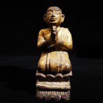 A wooden kneeling Burmese monk