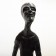 Wooden carving of a standing skinny man