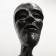 Wooden carving of a standing skinny man